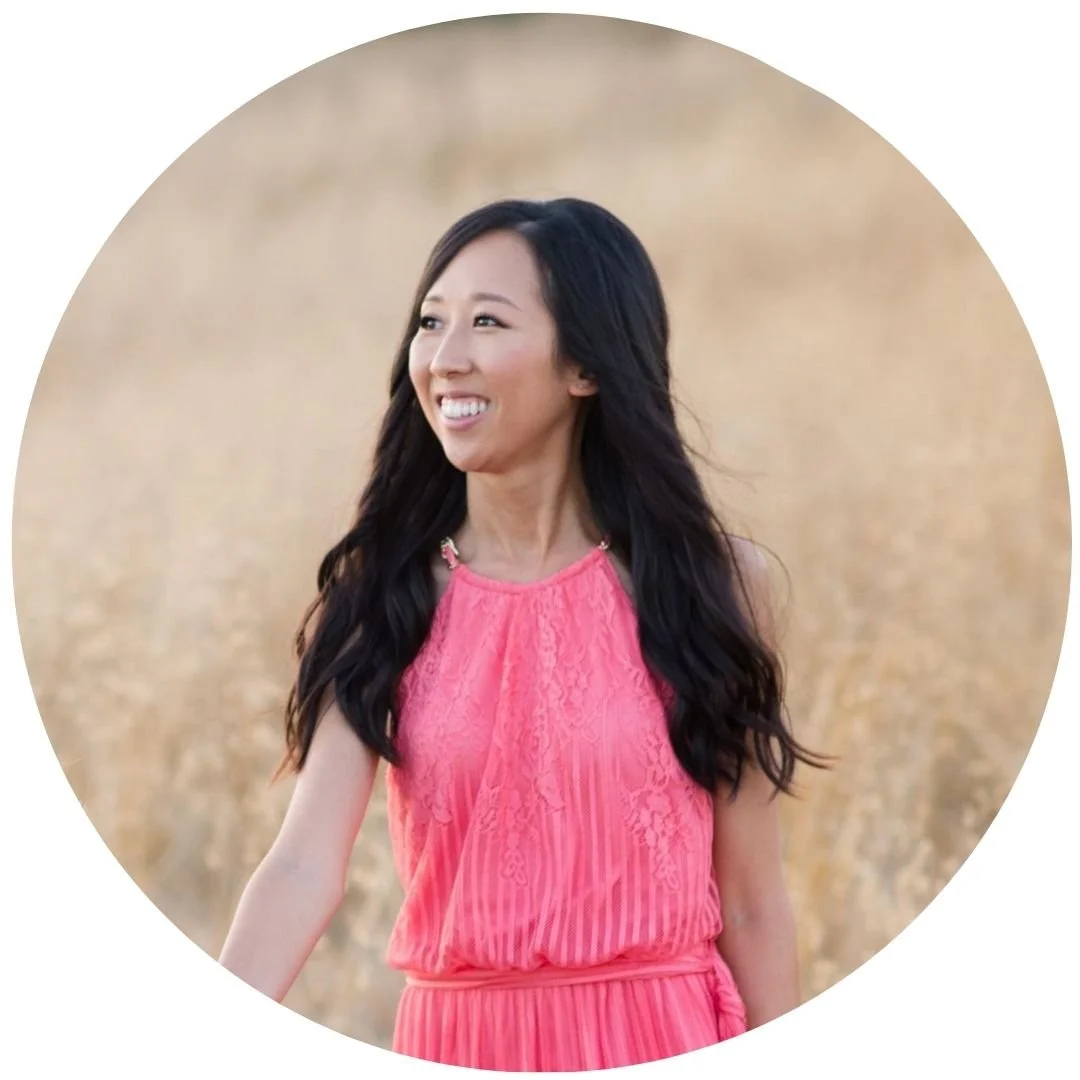 Vicky in a pink dress standing in a golden field